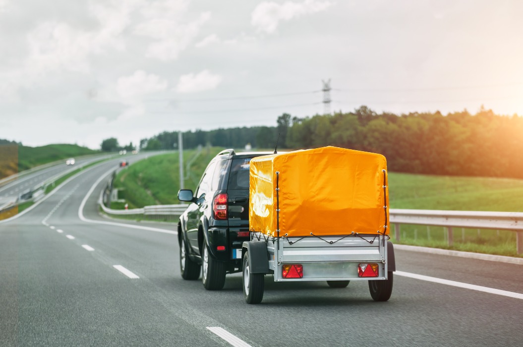 SUV and Rental Cargo Trailer on a Road. Efficient moving.