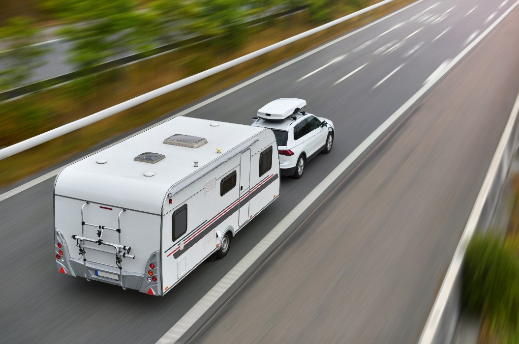 travel on car with caravan trailer by highway